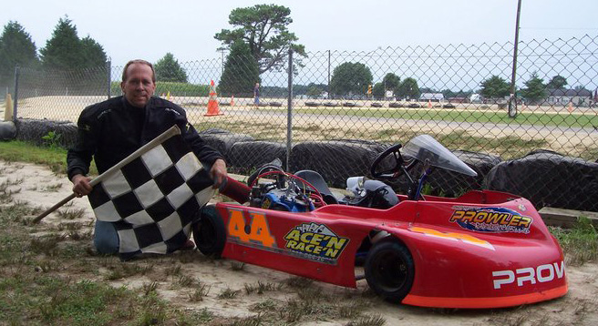 Ace posing next to his kart in 2009